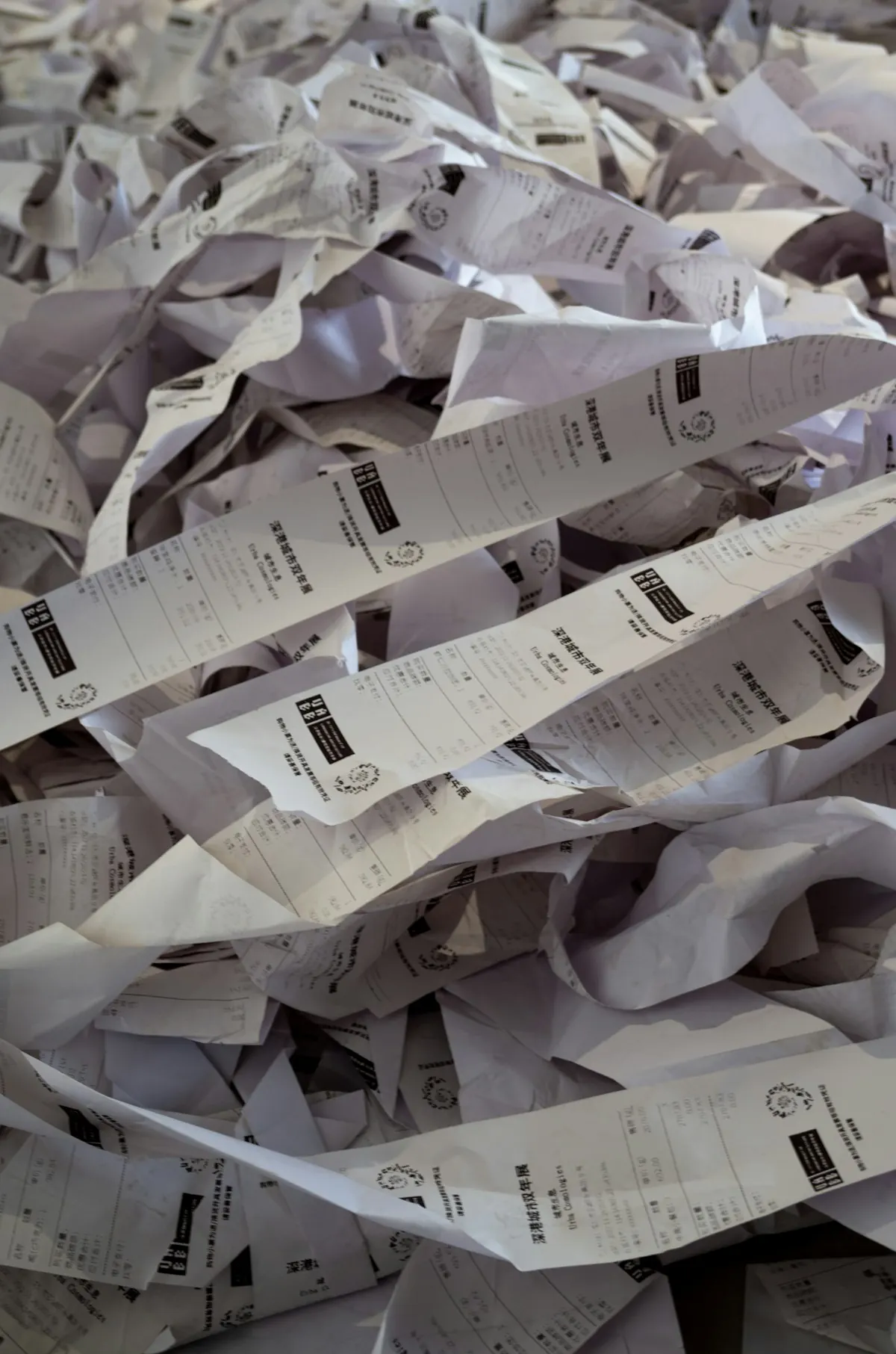A heap of crumpled paper receipts